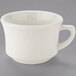 A white Tuxton china cup with an embossed rim and a handle.