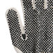 A close up of a Cordova warehouse glove with black PVC dots.