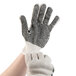 A pair of hands wearing Cordova work gloves with black PVC dotted palms.