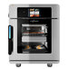 A stainless steel Alto-Shaam Vector H Series multi-cook oven with food in it.