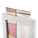 A Menu Solutions white wood framed menu tent with angled base holding a menu.