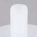 A white plastic cylinder with a white plastic cap and a screw in the middle.