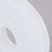 A close-up of white Nemco feeder discs with a hole in the center.