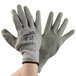 A pair of Cordova medium Cor-Grip II gloves with grey crinkle latex palms on a white background.