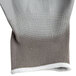 A pair of gray and white knit gloves with white cuffs.
