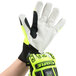 A hand wearing a lime green Cordova OGRE work glove with black and yellow accents.