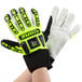 A person wearing lime green and black Cordova OGRE heavy duty work gloves with TPR reinforcements.