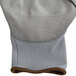 A close-up of a gray Cordova warehouse glove with gray palm coating.