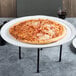 An American Metalcraft white ceramic pizza tray with a pizza on it.