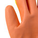 A close up of a large Cordova warehouse glove with a yellow body and orange palm coating.