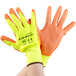 A pair of large yellow and orange Cordova warehouse gloves with orange palm coating.