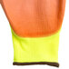 A pair of yellow gloves with orange trim and orange palm coating.