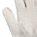A close up of a white Cordova Loop-Out terry work glove with a thumb.
