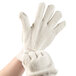 A hand wearing a Cordova Loop-Out Natural terry work glove.