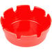 A close-up of a red plastic ashtray with a lid on top.
