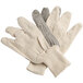 A pair of Cordova white cotton gloves with black dots on the palm.