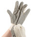 A pair of Cordova warehouse gloves with black PVC dots on the palm.