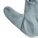 A close up of a Cordova white nylon glove with gray foam nitrile palm coating.