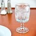 An Anchor Hocking Breckenridge goblet of ice water on a table.