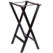A brown wooden folding tray stand with two legs.