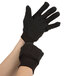 A pair of Cordova brown jersey gloves with black mini-PVC dots on the palms.