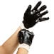 A pair of hands wearing Cordova black gloves.