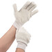 A pair of hands wearing Cordova Loop-Out natural terry work gloves with white jersey gloves over them.