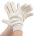 A pair of hands wearing white Cordova loop-out terry work gloves.