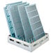A MetroMax Q shelving unit with white plastic grids holding blue plastic trays.