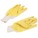 A pair of Cordova Ruffian yellow crinkle latex gloves with canvas lining over white gloves.
