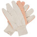 A pair of large white cotton work gloves with orange PVC dots on the palms.