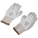 A pair of Cordova HPPE gloves with gray polyurethane palms and white fabric.