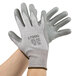 A pair of extra large Cordova HPPE gloves with gray polyurethane palm coating.