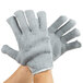 A pair of hands wearing gray Cordova loop-in work gloves.