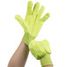 A pair of hands wearing hi-vis yellow Cordova work gloves.