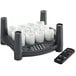 A black candle holder with a white Sterno flameless votive and a black remote control.