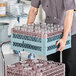 A Noble Warewashing 20-compartment gray full-size glass rack with one brown extender, used for holding and washing glassware.
