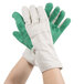 A pair of hands wearing green Cordova work gloves.