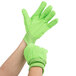 A pair of hands wearing green Cordova work gloves.