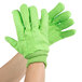 A pair of lime green Cordova work gloves with a white background.
