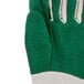 A close up of a Cordova green cotton work glove with white stitching.