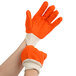 A pair of orange Cordova work gloves with a white double palm.