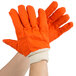 A pair of orange Cordova Hi-Vis work gloves with white double palms.