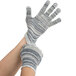 A pair of hands wearing grey and white Cordova work gloves.