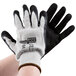 A pair of black and gray gloves with white HPPE, steel, and glass fibers.