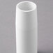 A white PVC pipe on a gray surface.