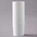 A white cylindrical object on a gray surface with a white lid.