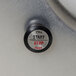 A close-up of a black push button with a black circle.