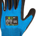 A close up of a Cordova blue and black work glove with a black nitrile palm coating.