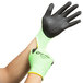 A pair of large Cordova lime green and black gloves with a black nitrile palm coating.